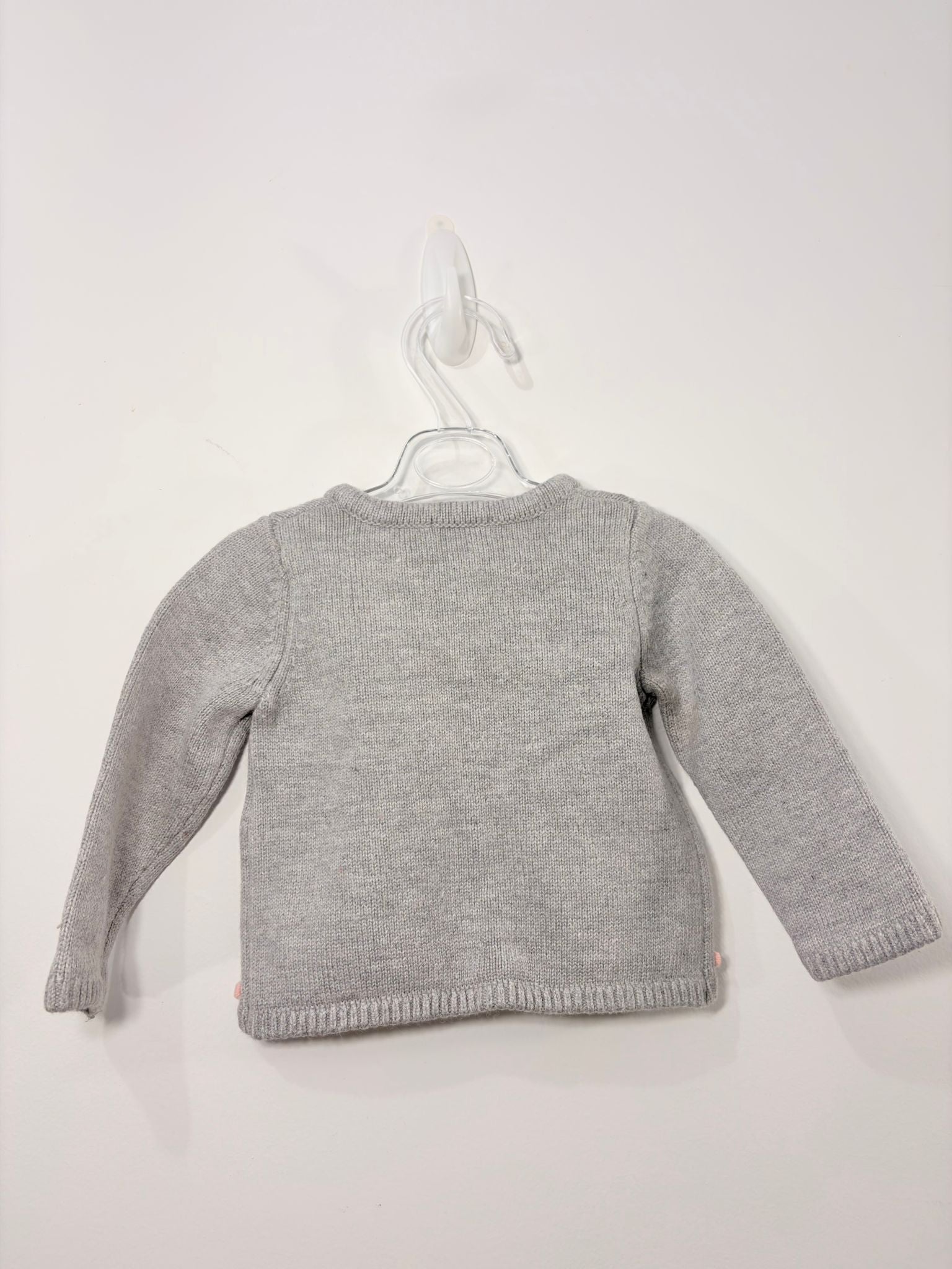 Gilet avec des petits pompons