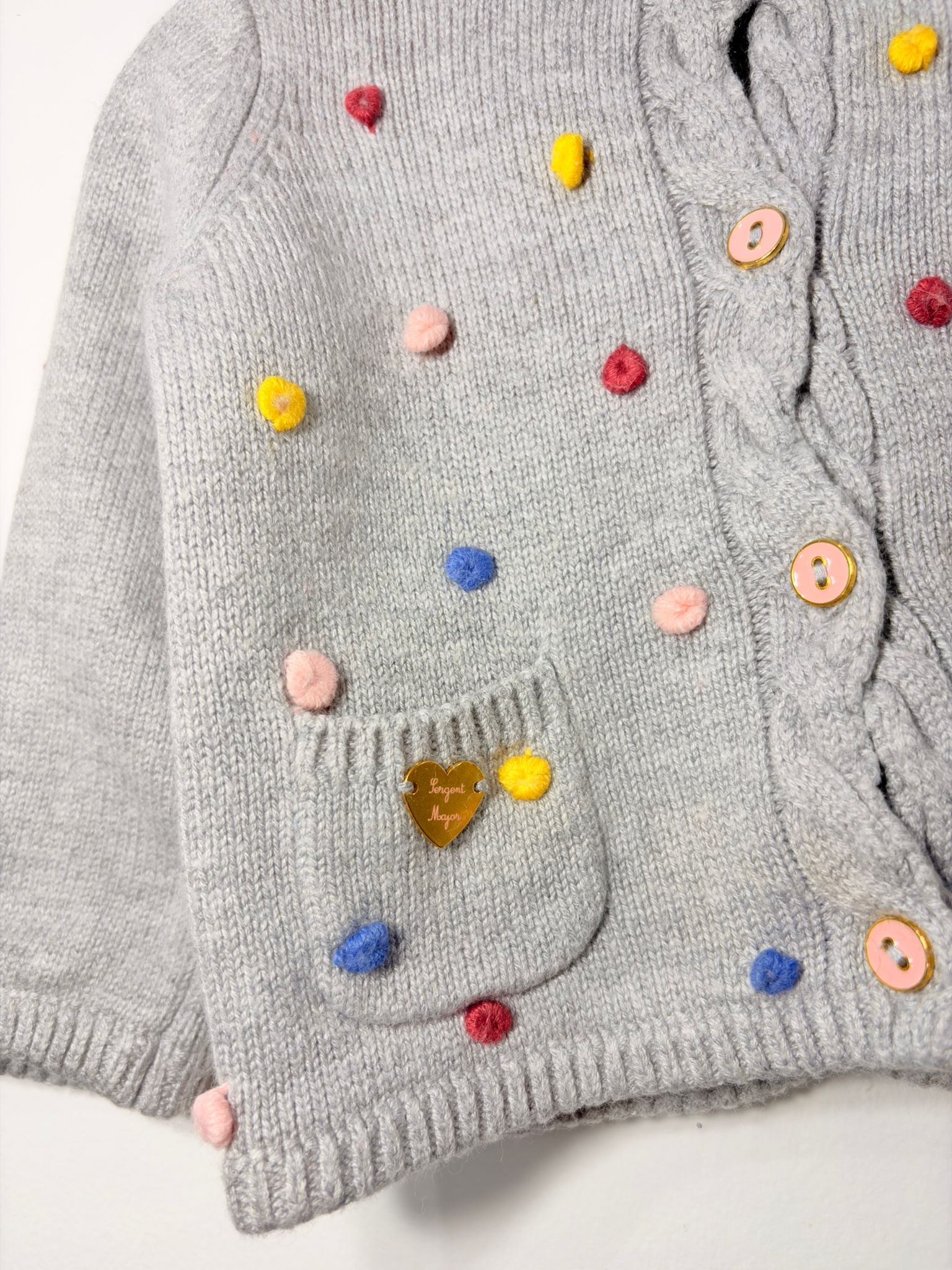 Gilet avec des petits pompons