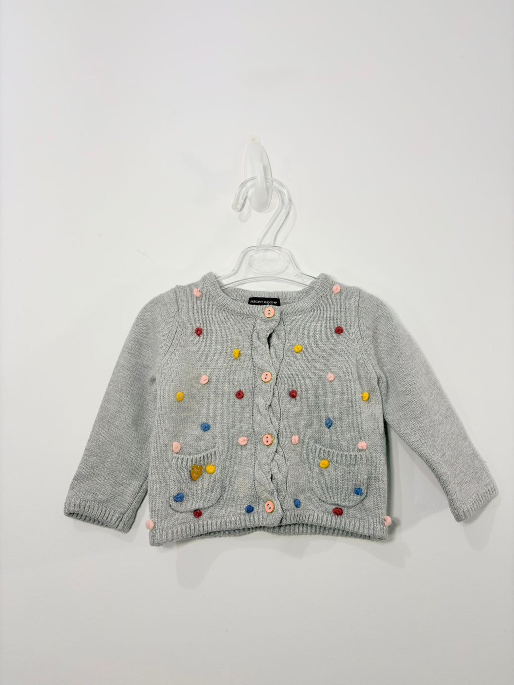 Gilet avec des petits pompons