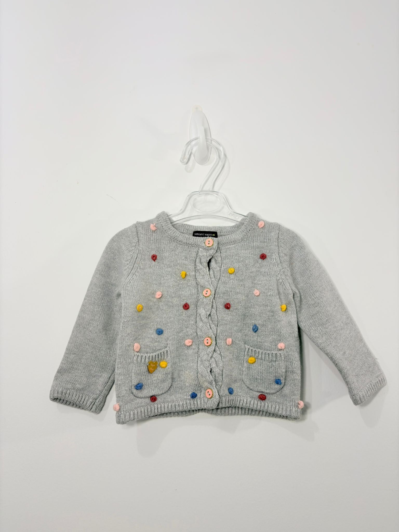 Gilet avec des petits pompons